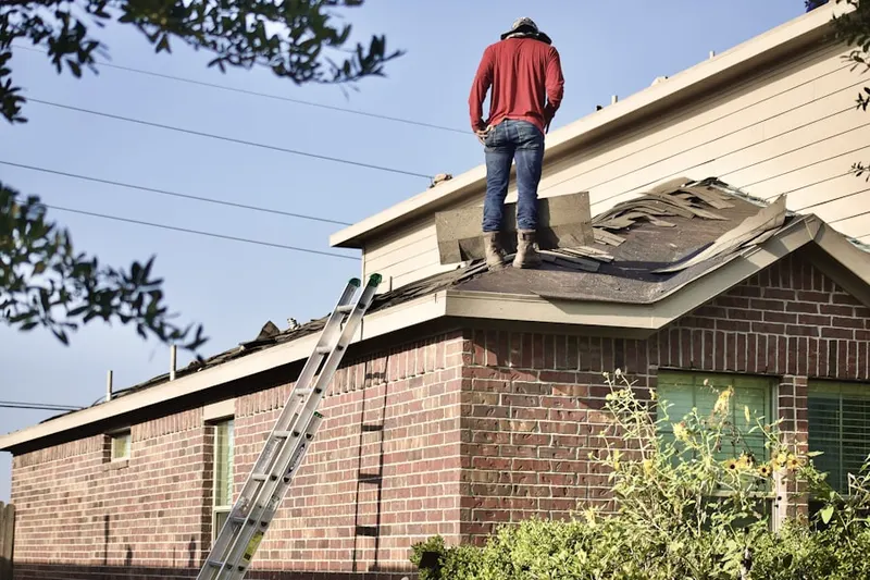 Professional roofer working on a residential roof in Norwell